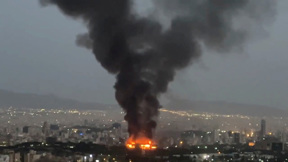להבות ועשן מיתמר מעל זירת תקיפה בטהראן, איראן